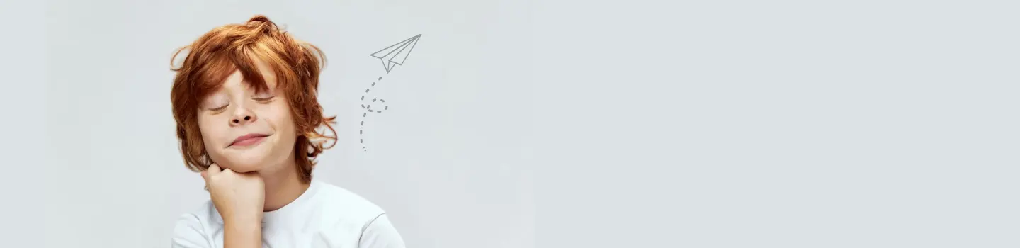 Rothaariges Kind, das mit der Hand am Kinn nachdenklich wirkt und intuitive Gedanken und Entscheidungen symbolisiert.