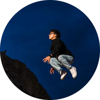 A man jumps high against a starry night, representing the courage to overcome limitations and discover his full potential.