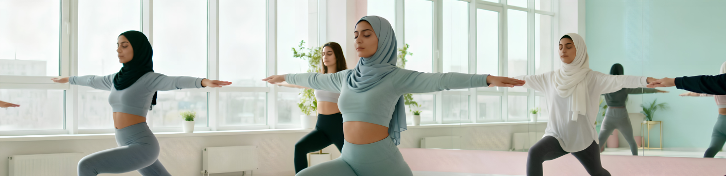 Yoga class in a studio with diverse participants performing yoga asanas