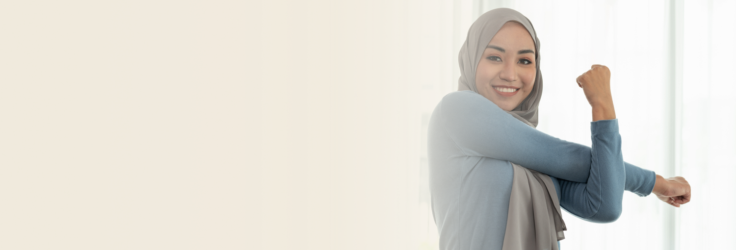 Smiling woman wearing a hijab stretching her arms