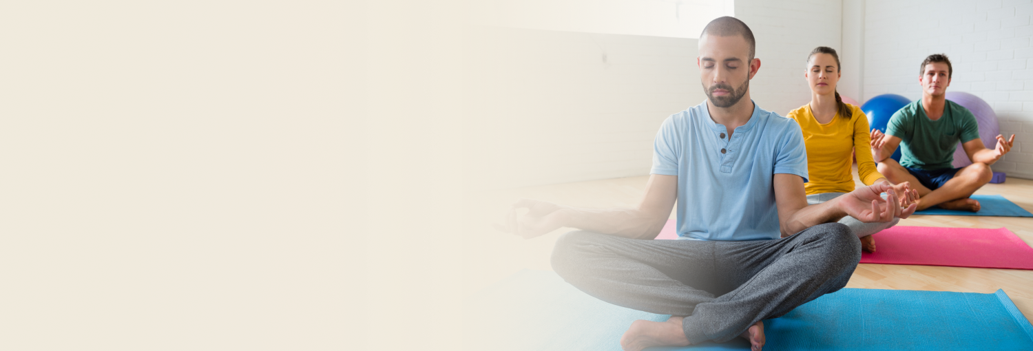 Group of people meditating indoors for wellness