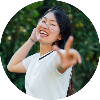 A woman in white t-shirt similing happily representing level 2 yoga helping in accomplishing your dreams