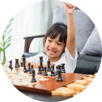 Young girl in white shirt playing chess, focused on developing strategic thinking skills.