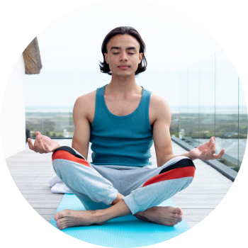 A teenage boy in sports wear, sitting in outdoor space and meditating in Shuni mudra
