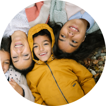 Diverse group of kids lying next to each other and smiling