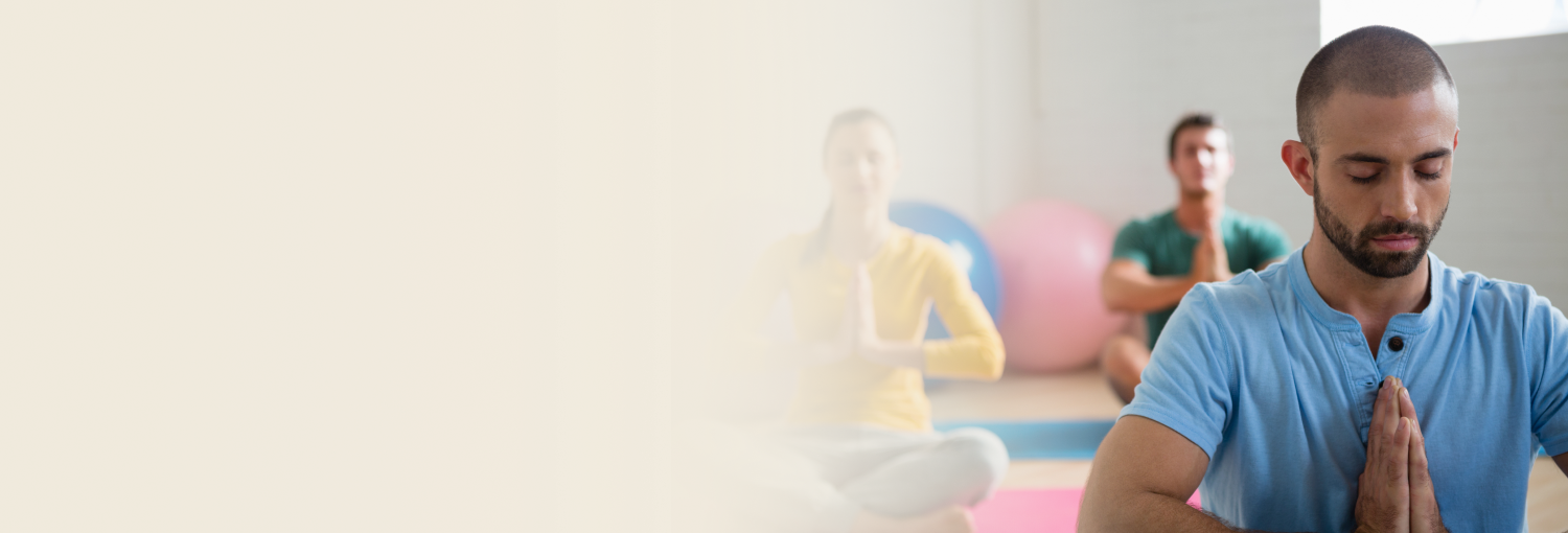 Group of people meditating indoors for wellness