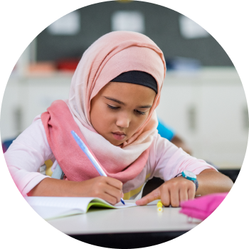 A kid with pink hijab taking notes with keen focus and attention
