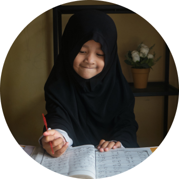 A kid with black burqa writing in her note book and enjoying learning