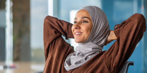A woman resting peacefully on a chair with a serene expression, representing relaxation.
