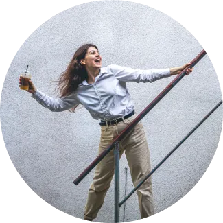 A woman stands on the stairs, arms outstretched, embracing freedom and overcoming her fears with confidence