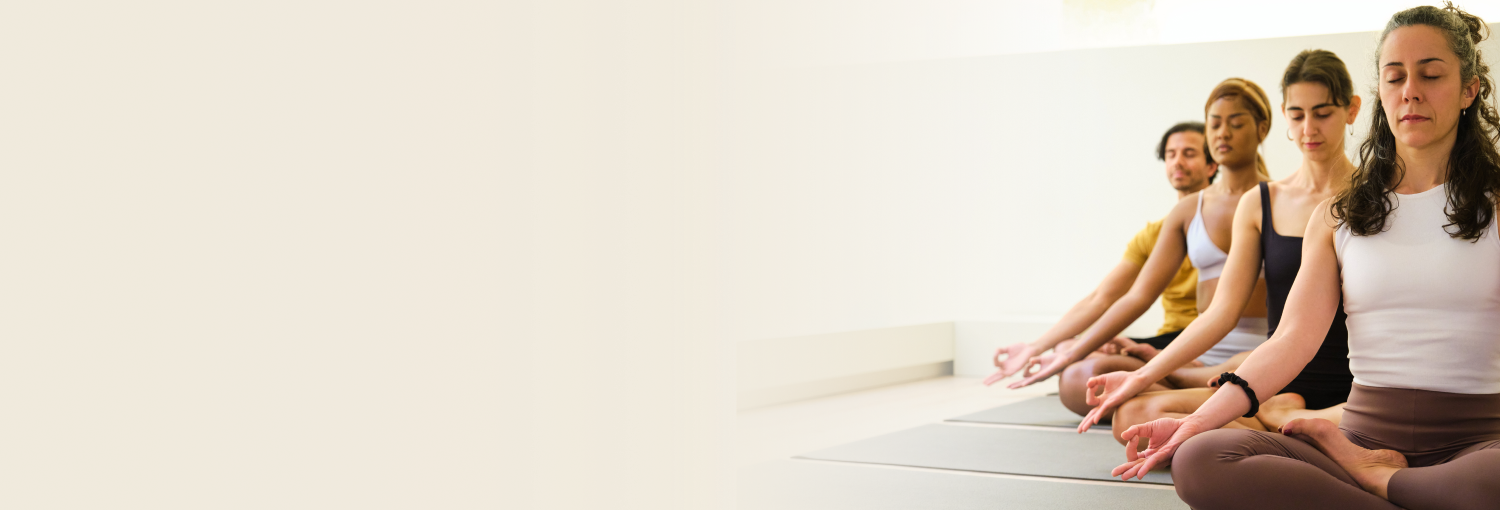 Participants sitting in meditation pose practising breathing techniques